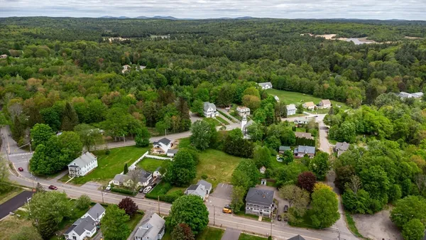an aerial view of a house with a yard