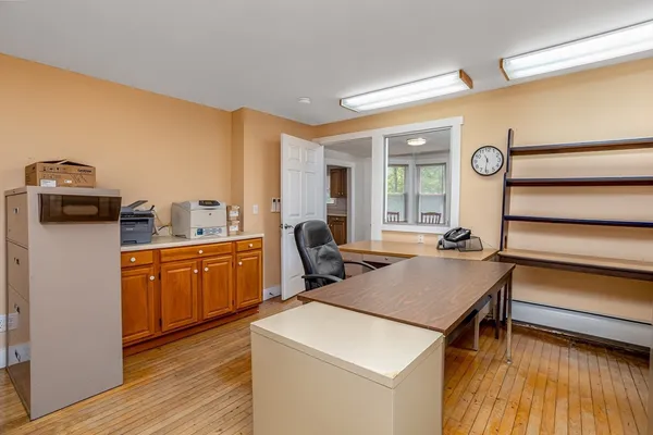 a very nice looking sitting area with kitchen countertops and wooden floor