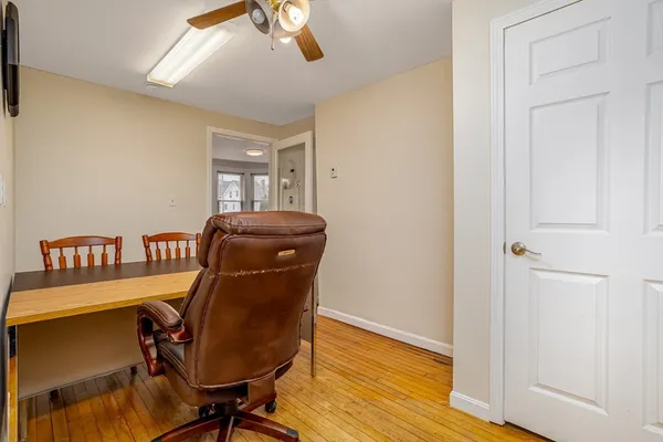 a view of workspace with wooden floor windows