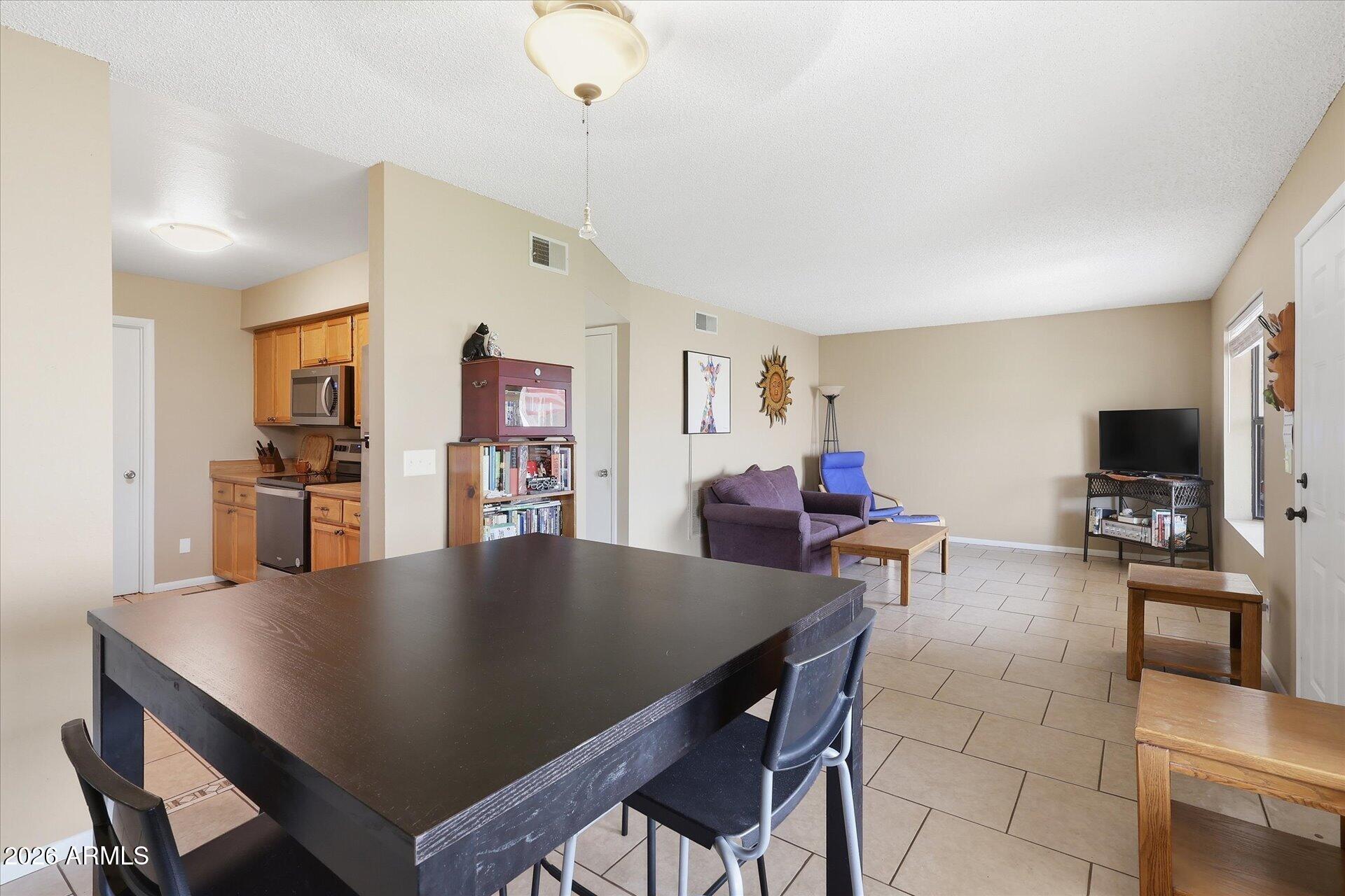3270 South Goldfield Road, Unit 716 Apache Junction, AZ 85119 - Photo 8 of 36 a view of a dining room with furniture and a livingroom