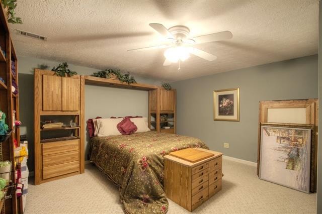 868 Reed Road Ten Mile, TN 37880 - Photo 29 of 40 a bedroom with a bed and a chandelier