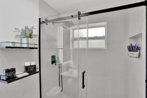 a bathroom with a shower and a bath tub