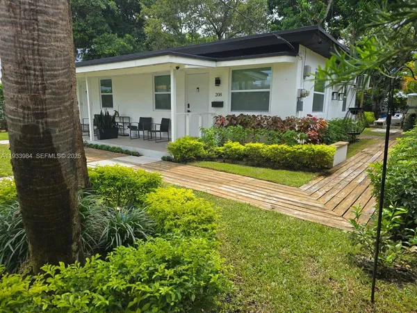 a front view of a house with garden