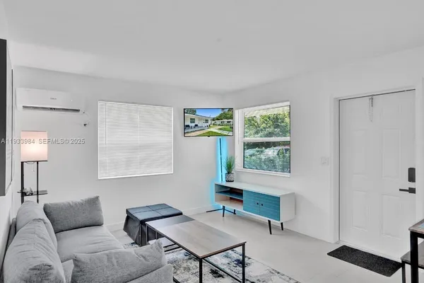 a living room with furniture and a window