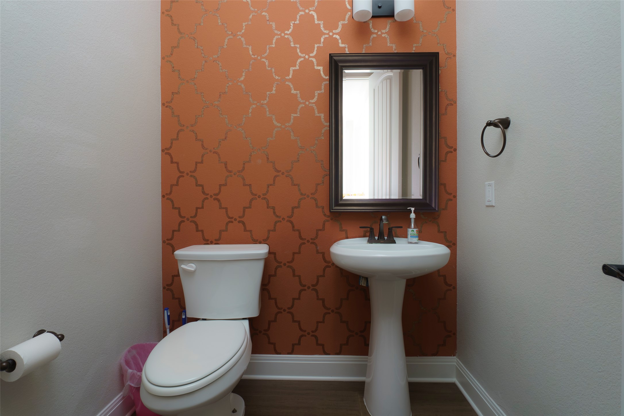 2305 Millbrook Loop Leander, TX 78641 - Photo 22 of 26 A well-appointed powder room features a pedestal sink and decorative accent wall.