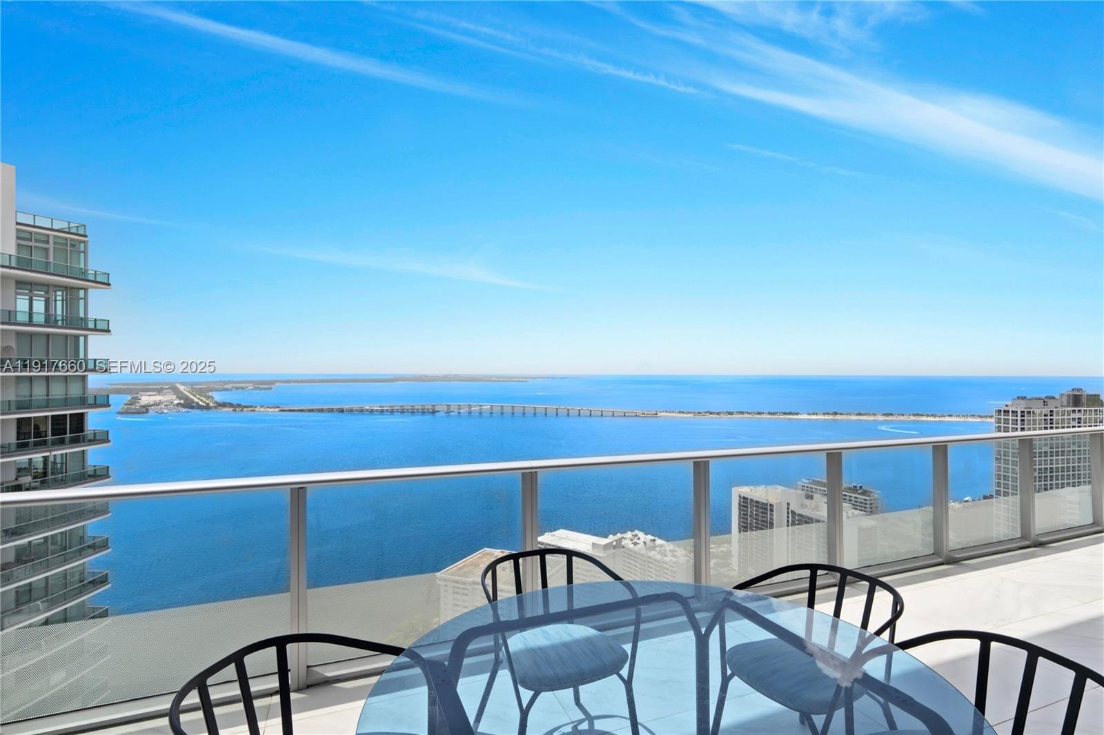 1300 Brickell Bay Drive, Unit 4401 Miami, FL 33131 - Photo 13 of 34 a view of a chairs and table in the balcony