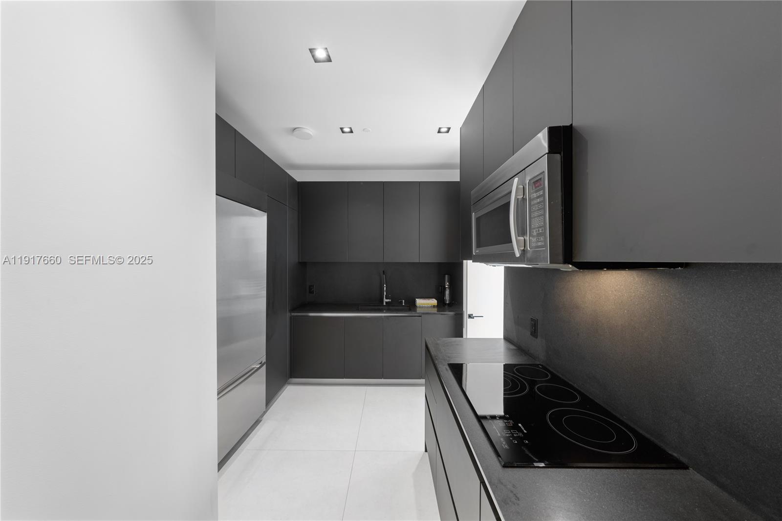 1300 Brickell Bay Drive, Unit 4401 Miami, FL 33131 - Photo 24 of 34 a kitchen with stainless steel appliances a refrigerator and a stove