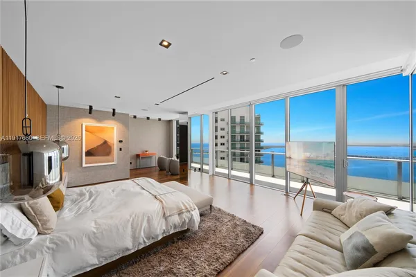 a living room with furniture and a floor to ceiling window