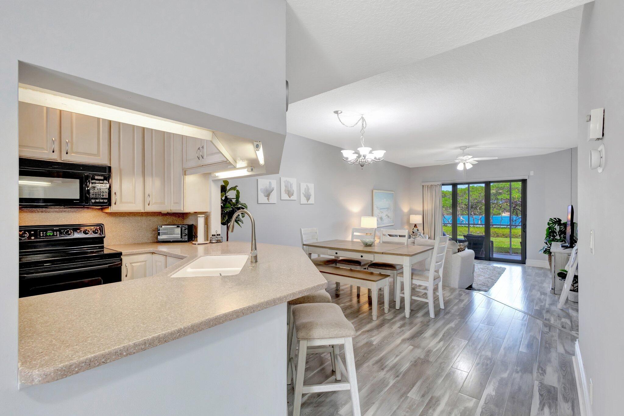 200 Waterway Road, Unit 109 Tequesta, FL 33469 - Photo 11 of 43 200 Waterside - Kitchen + Living