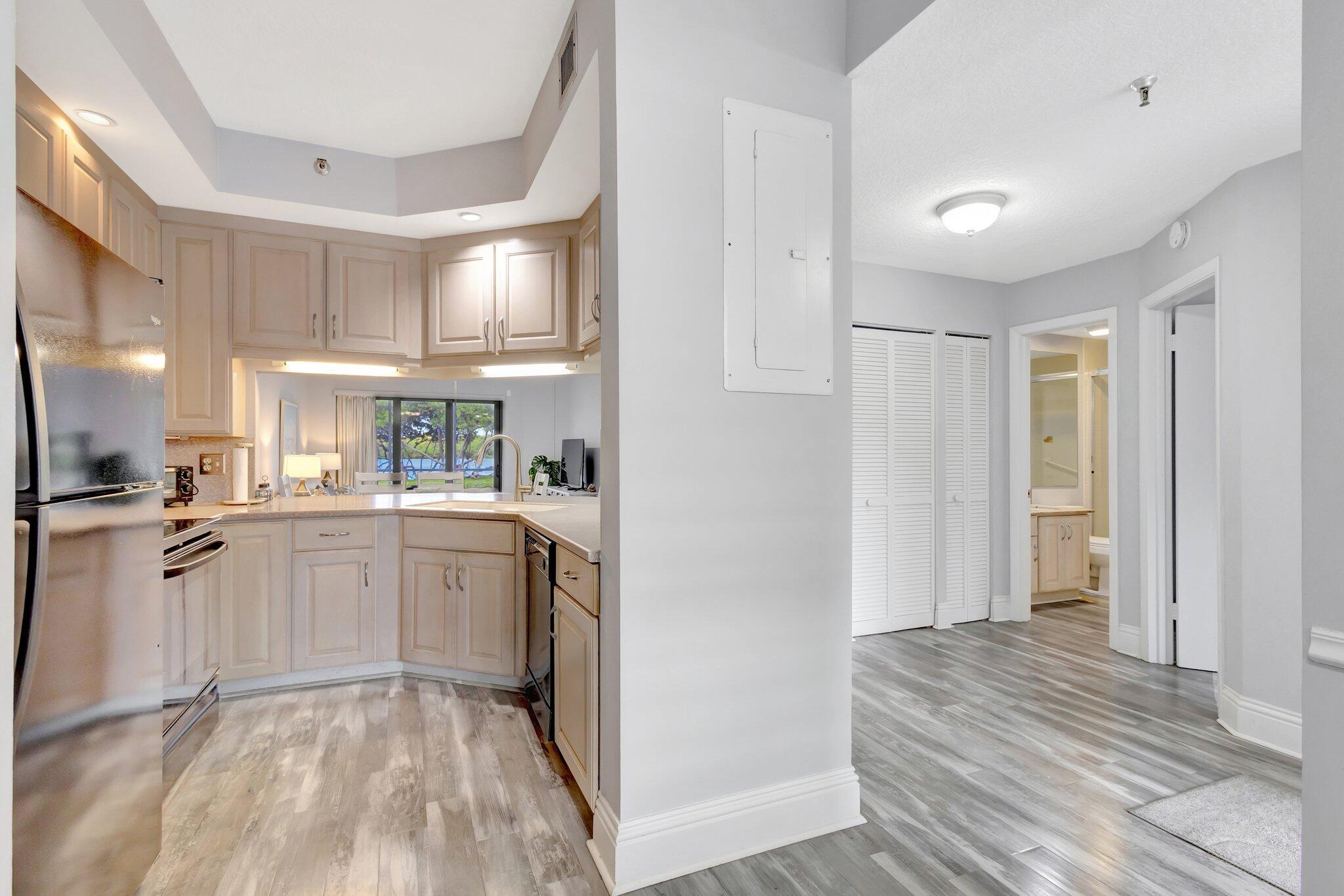 200 Waterway Road, Unit 109 Tequesta, FL 33469 - Photo 15 of 43 200 Waterside 109 - Kitchen + Hallway