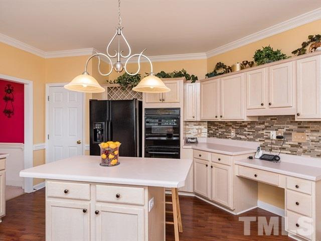 3553 Dewing Drive Raleigh, NC 27616 - Photo 11 of 25 a kitchen with a sink dishwasher white cabinets and stainless steel appliances