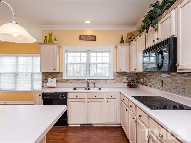 3553 Dewing Drive Raleigh, NC 27616 - Photo 13 of 25 a kitchen with a sink stove and cabinets
