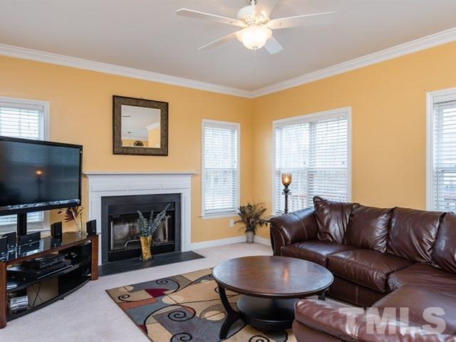 3553 Dewing Drive Raleigh, NC 27616 - Photo 15 of 25 a living room with furniture a flat screen tv and a fireplace