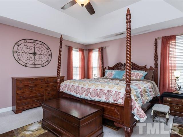 3553 Dewing Drive Raleigh, NC 27616 - Photo 17 of 25 a bedroom with a bed a large window and dresser