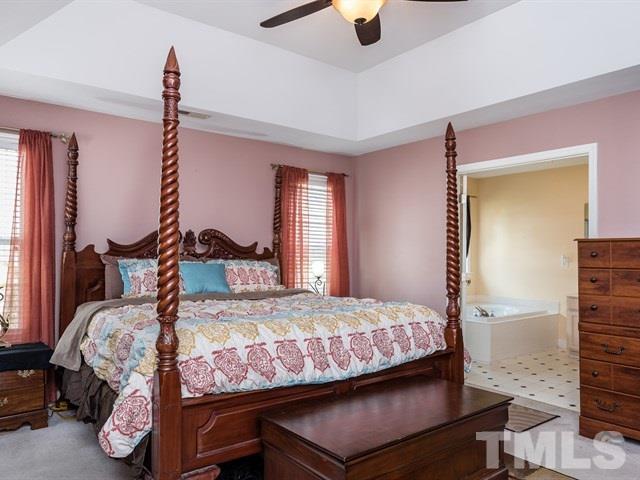 3553 Dewing Drive Raleigh, NC 27616 - Photo 18 of 25 a bedroom with a bed and wooden floor