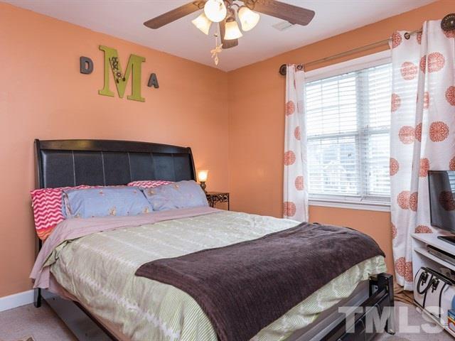 3553 Dewing Drive Raleigh, NC 27616 - Photo 21 of 25 a bedroom with a large bed and a chandelier