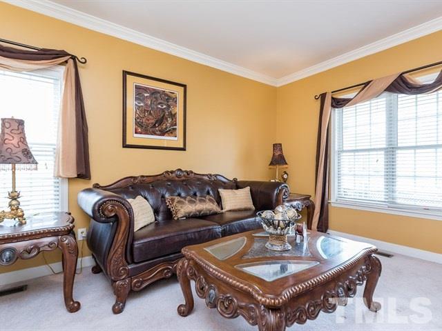 3553 Dewing Drive Raleigh, NC 27616 - Photo 5 of 25 a living room with furniture a window and a table