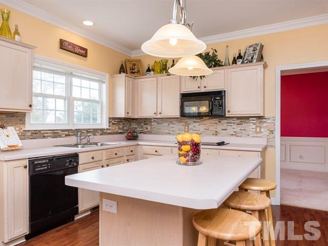3553 Dewing Drive Raleigh, NC 27616 - Photo 8 of 25 a kitchen with a sink a stove and chairs