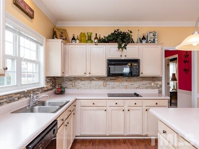 3553 Dewing Drive Raleigh, NC 27616 - Photo 9 of 25 a kitchen with stainless steel appliances granite countertop a sink and a stove