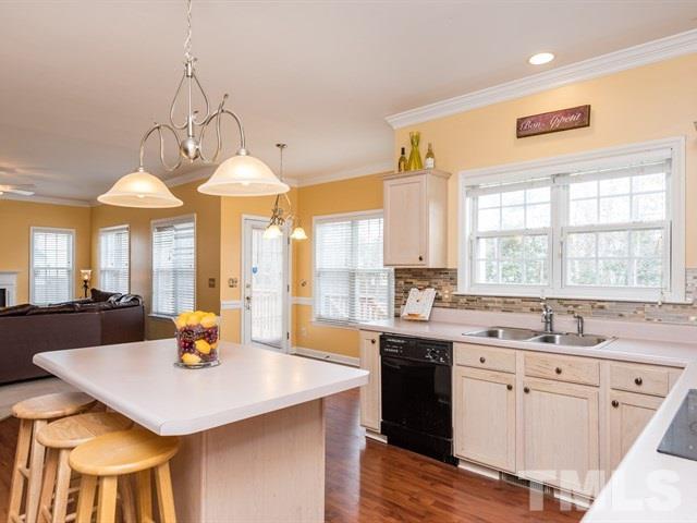 3553 Dewing Drive Raleigh, NC 27616 - Photo 10 of 25 a kitchen with a sink stove and cabinets