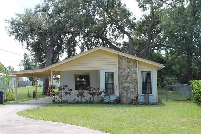 a view of a house with a yard and plants