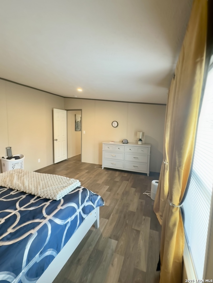 4858 Stanislaus Adkins, TX 78101 - Photo 11 of 19 a bedroom with a bed and wooden floor