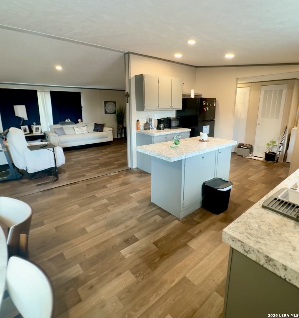 4858 Stanislaus Adkins, TX 78101 - Photo 5 of 19 a large kitchen with a large counter top furniture appliances and wooden floor