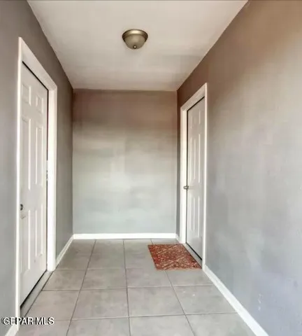 a living room with a couch and a view of kitchen