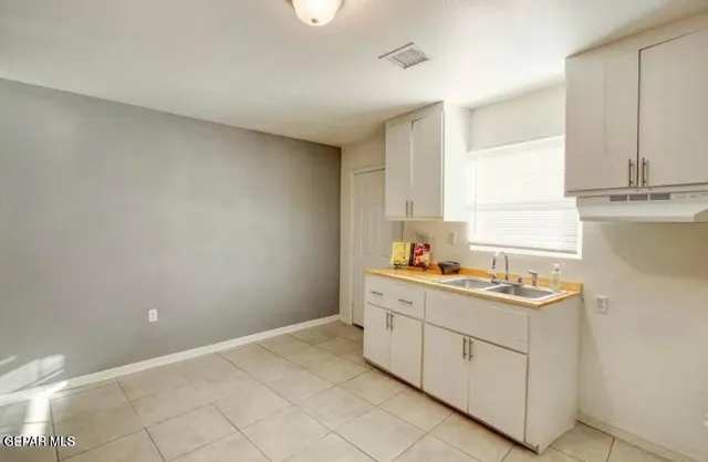 a bathroom with a sink a toilet a shower and a mirror