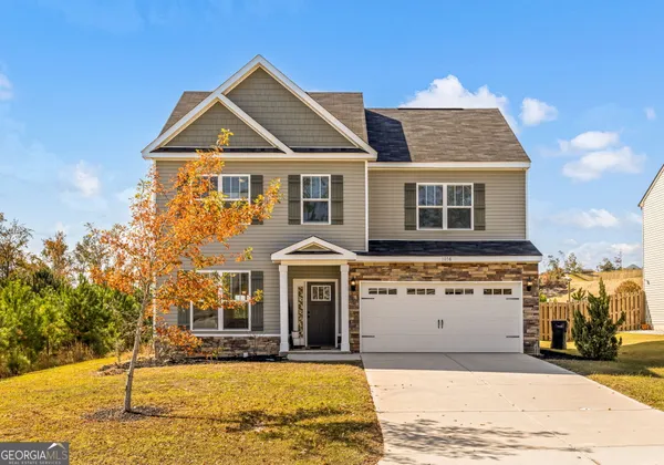 a front view of a house with a yard