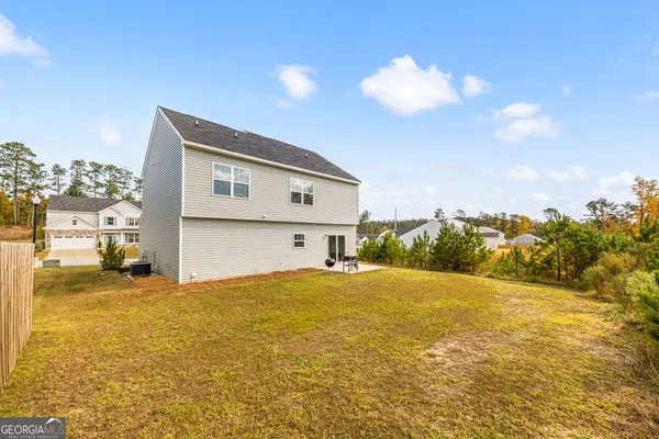 a house with lots of trees in the background