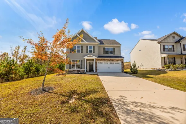 a front view of a house with a yard