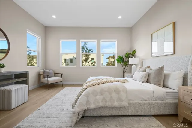 a bedroom with bed and a large window