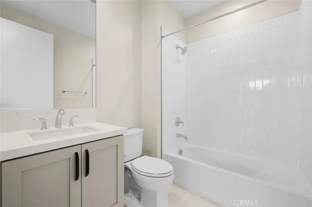 a bathroom with a sink toilet vanity and shower