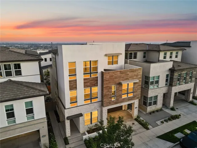 a front view of a residential apartment building with a yard