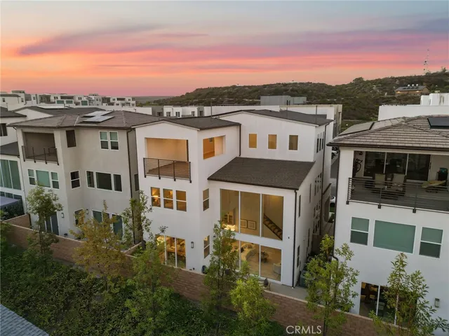 a view of a white house with a yard