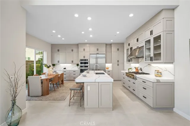 a large white kitchen with a large window