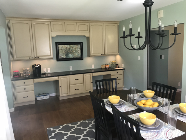 307 Prairie Street Spring Valley, IL 61362 - Photo 12 of 21 a kitchen with stainless steel appliances granite countertop a sink a stove a dining table and chairs with wooden floor