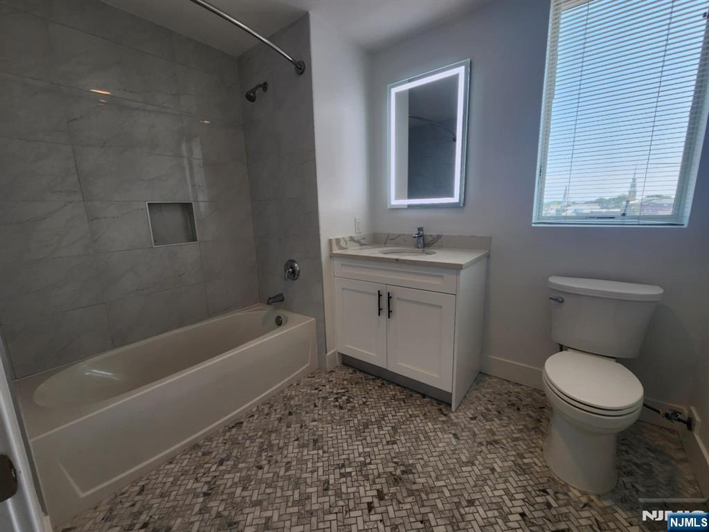 77 Ridge, Unit 306 North Arlington, NJ 07031 - Photo 11 of 23 a bathroom with a toilet sink and bathtub