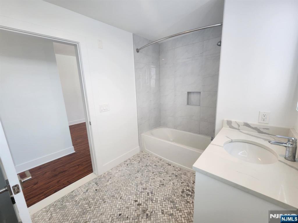 77 Ridge, Unit 306 North Arlington, NJ 07031 - Photo 12 of 23 a bathroom with a sink and a tub