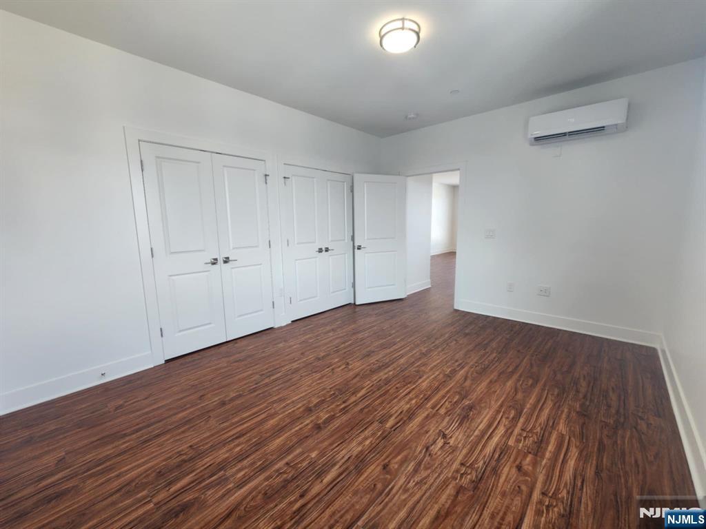 77 Ridge, Unit 306 North Arlington, NJ 07031 - Photo 14 of 23 a view of an empty room with wooden floor