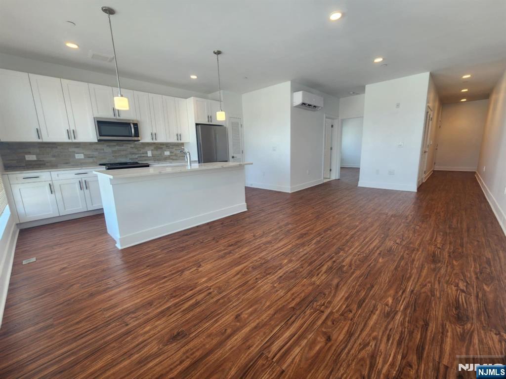 77 Ridge, Unit 306 North Arlington, NJ 07031 - Photo 5 of 23 a view of kitchen with cabinets appliances and wooden floor