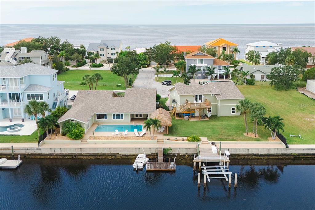 an aerial view of house with yard swimming pool and outdoor seating