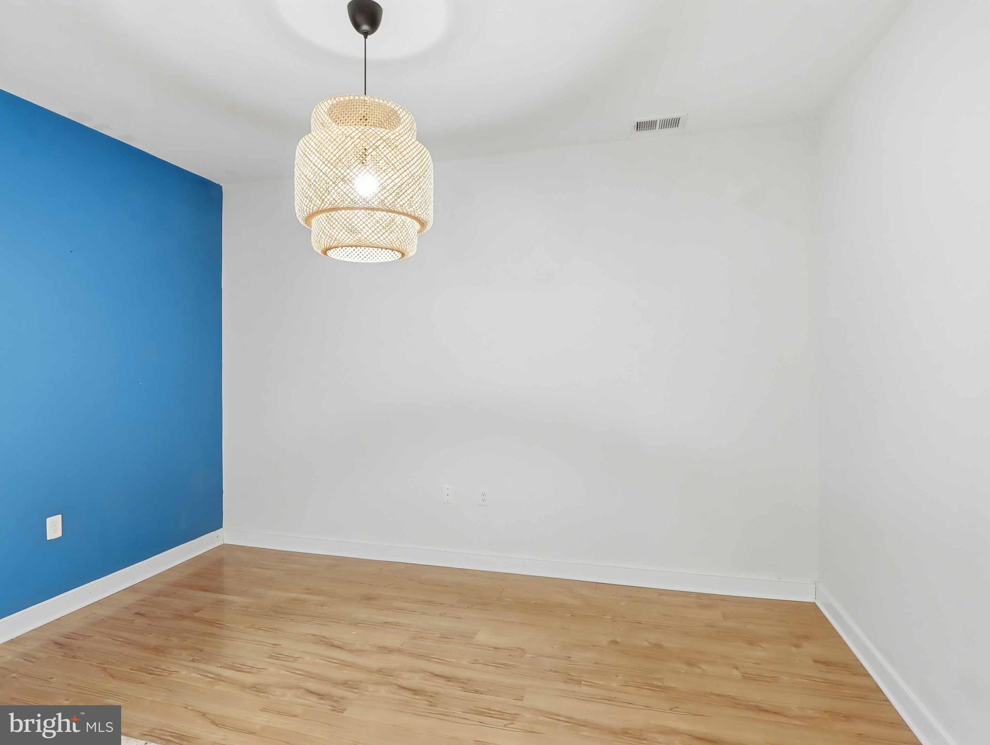 8005 13th Street, Unit 411 Silver Spring, MD 20910 - Photo 26 of 33 a room with wooden floor and a window