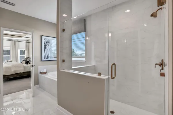 a bedroom with a bed and a mirror