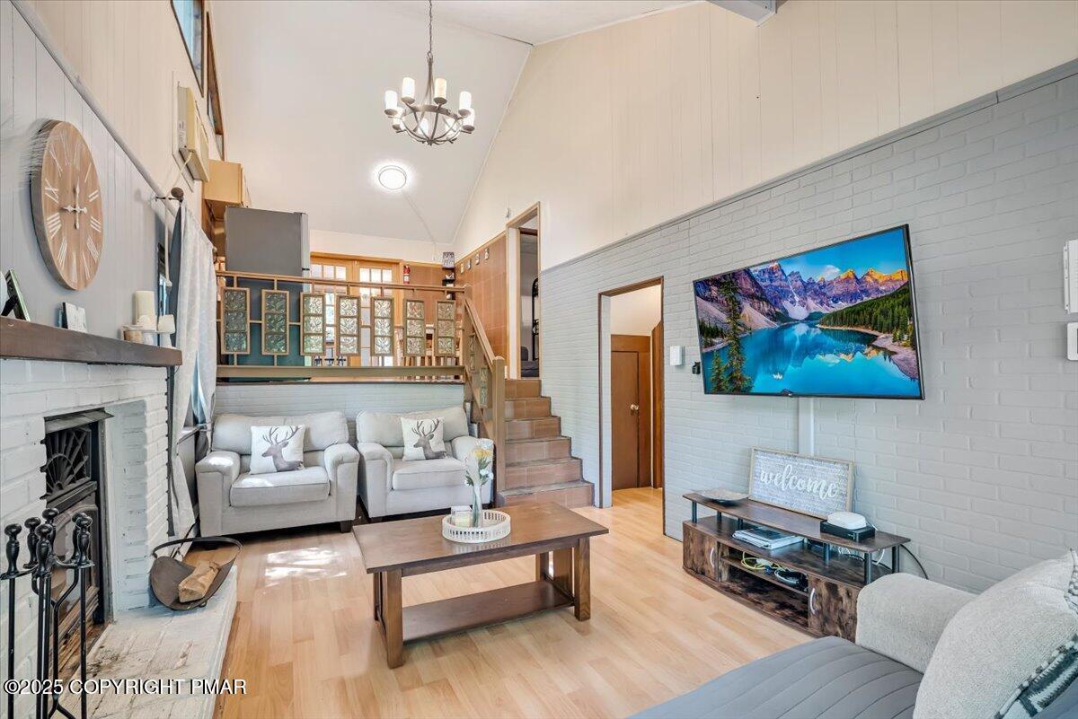 2108 Scarborough Way Bushkill, PA 18324 - Photo 103 of 105 a living room with furniture a fireplace and a flat screen tv