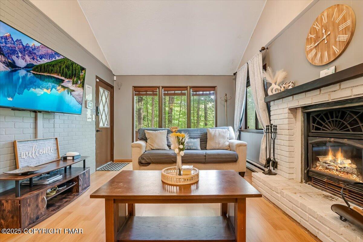 2108 Scarborough Way Bushkill, PA 18324 - Photo 12 of 105 a living room with furniture a fireplace and a flat screen tv