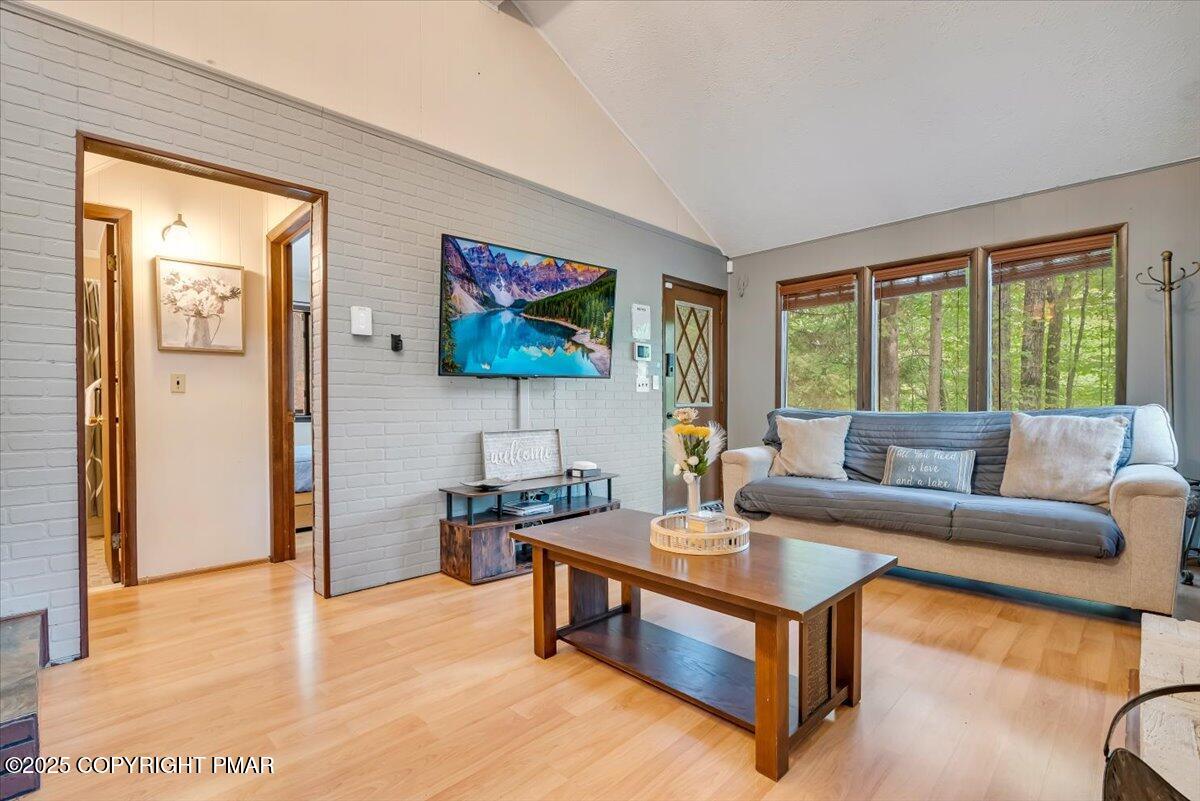 2108 Scarborough Way Bushkill, PA 18324 - Photo 17 of 105 a living room with furniture flat screen tv and a large window