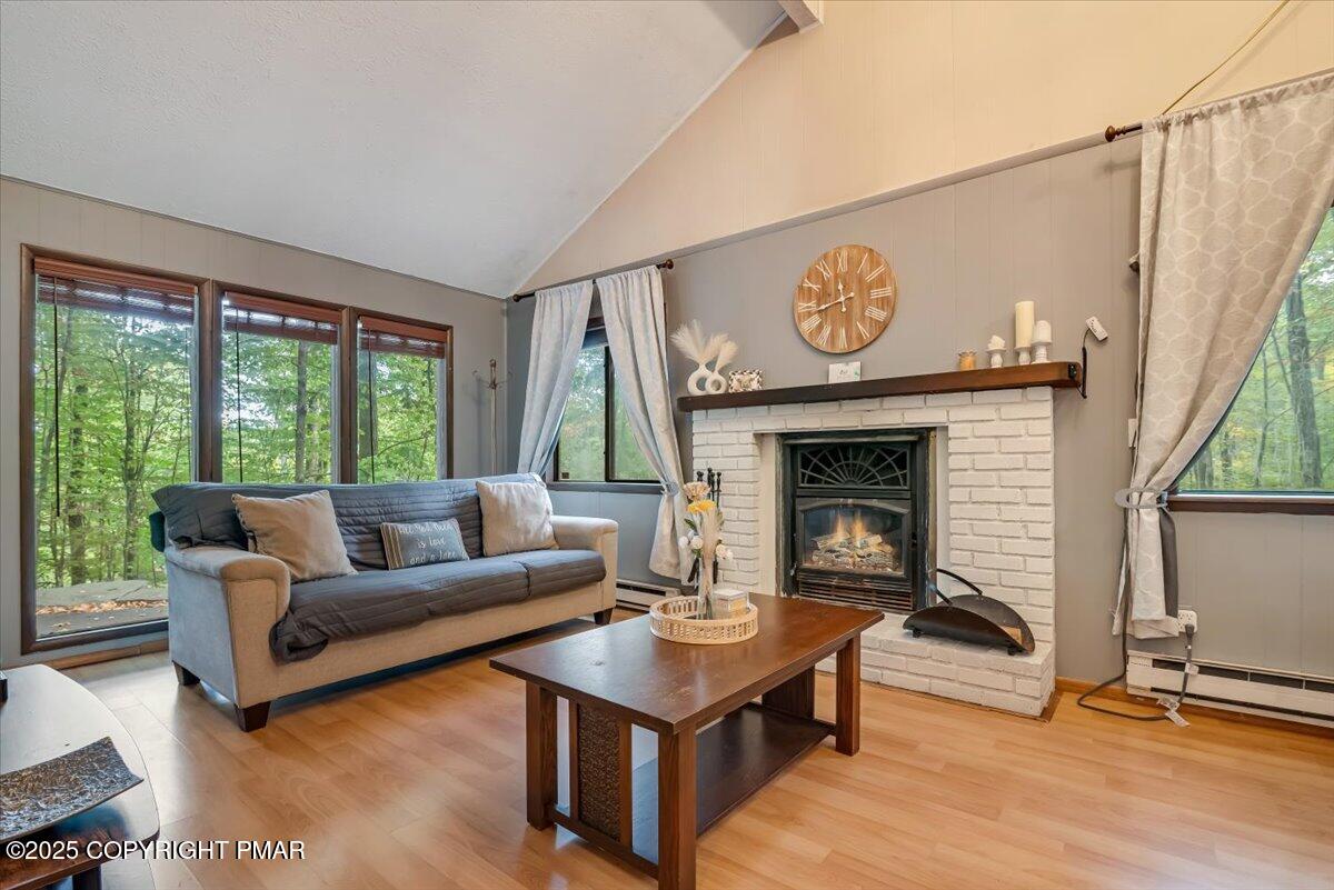 2108 Scarborough Way Bushkill, PA 18324 - Photo 18 of 105 a living room with furniture a window and a fireplace