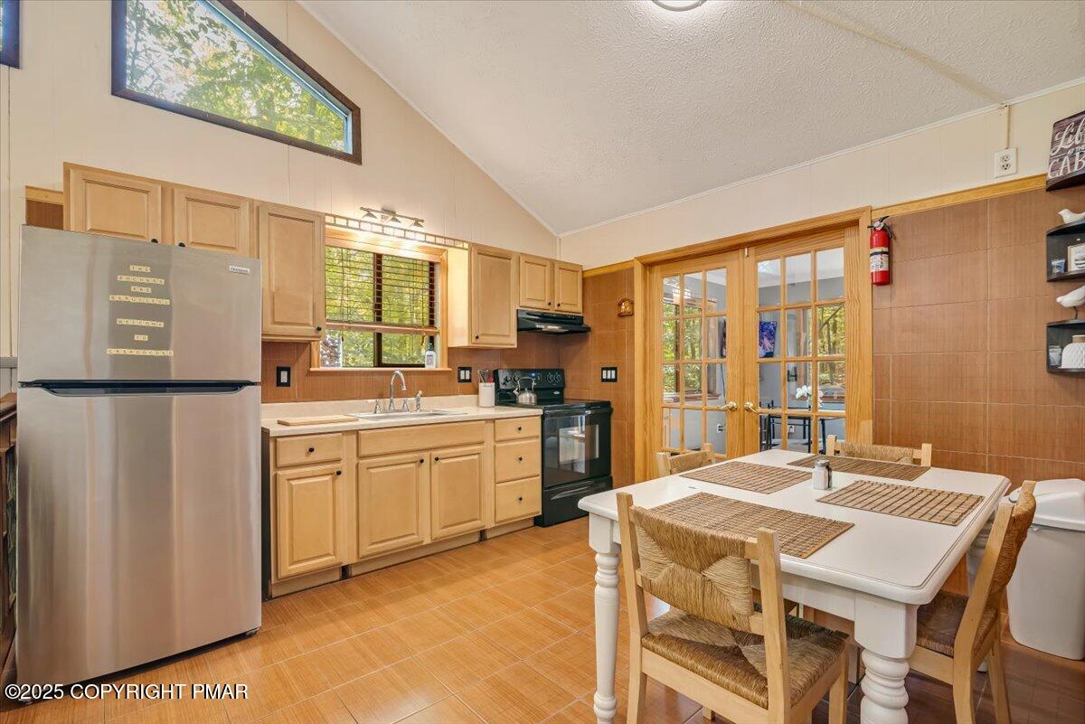 2108 Scarborough Way Bushkill, PA 18324 - Photo 22 of 105 a kitchen with stainless steel appliances granite countertop a sink a stove a refrigerator a dining table and chairs with wooden floor